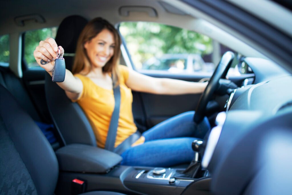 beautiful female women driver sitting her vehicle holding car keys ready drive